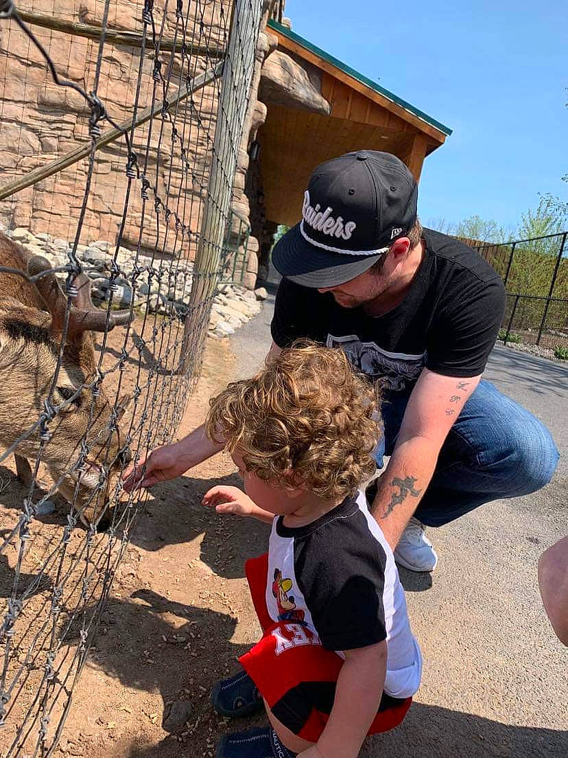 Amari is registered to the contest to win money with this photo: baseball_cap, cap, child, fun, hat, landscape, leisure, person, plant, recreation, rock, rope, shorts, sky, soil, spring, t_shirt, toddler, tree, wire_fencing