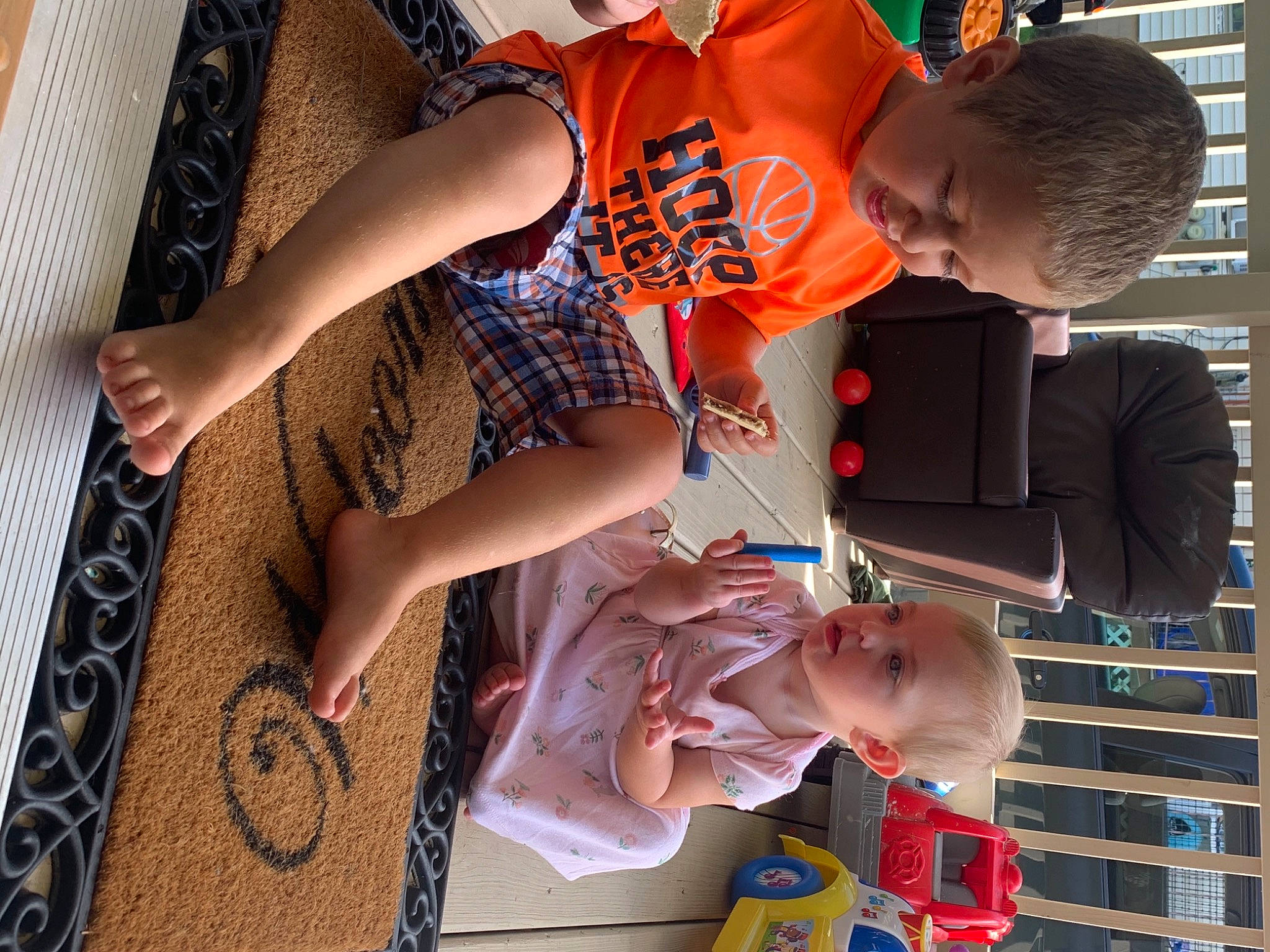 Malaya is registered to the contest to win money with this photo: child, elbow, eyewear, fashion_design, fun, happy, human_leg, leisure, pattern, person, plaid, room, sitting, t_shirt, thigh, toddler, visual_arts, wrist