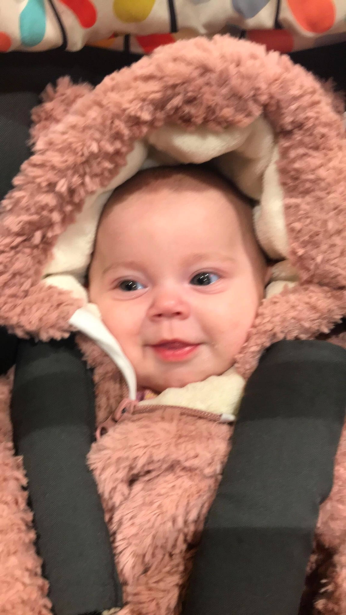 Isla-rose is registered to the contest to win money with this photo: baby, baby_carriage, baby_in_car_seat, baby_products, beige, car_seat, cheek, child, ear, fur, fur_clothing, head, headgear, person, skin, smile, toddler, wool
