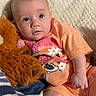 baby, infant, child, orange_clothing, stuffed_toy, blanket, soft_texture, cute, portrait, indoor, relaxed, lying_down, blue_blanket, plush_toy, small_hand, chubby_legs, looking_up, casual, comfortable, cozy