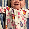 Kennedy joined the competition — help win amazing prizes! baby, infant, smile, face, onesie, owl_pattern, blanket, striped, happy, lying_down, child, cute, apparel, zipped, cheerful, young, person, indoors, portrait, skin