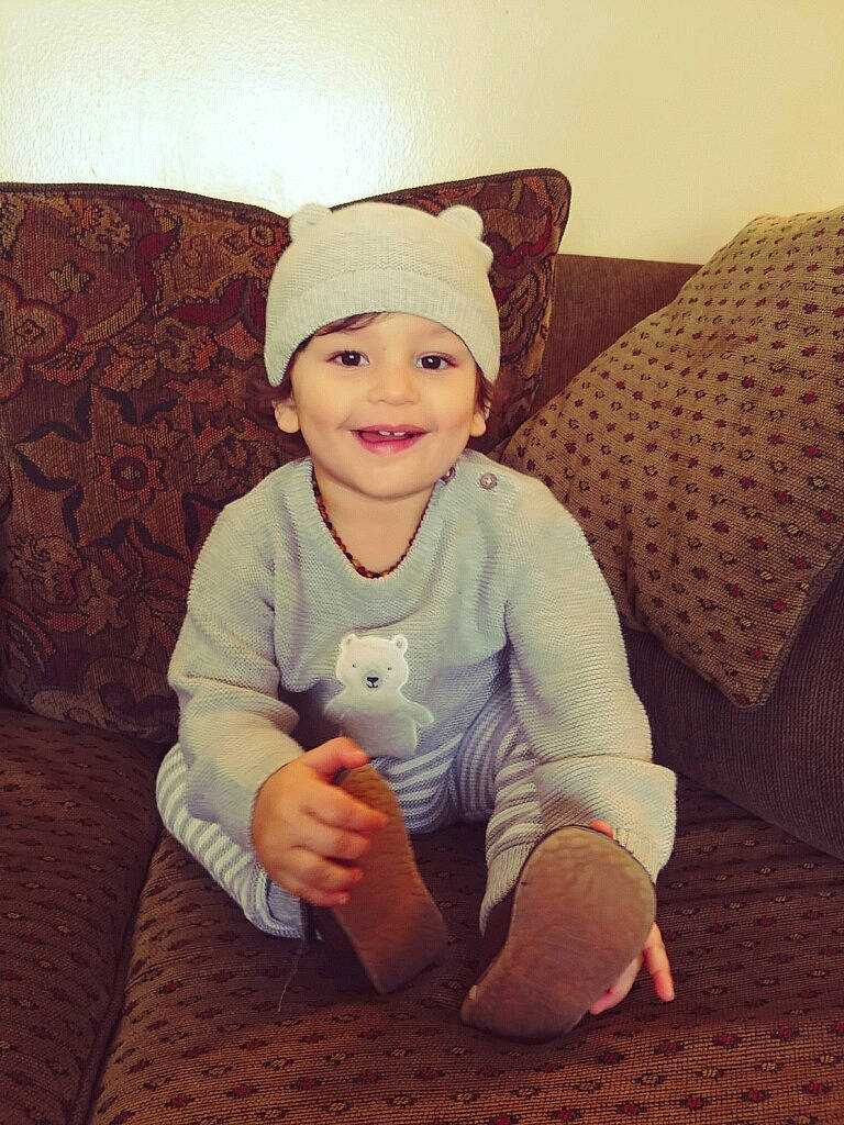 Jaylon is registered to the contest to win money with this photo: baby, bonnet, child, finger, happy, headgear, headwear, joy, person, sitting, smile, toddler