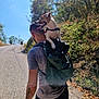 Milo a rejoint le concours — aidez-le/la à gagner de superbes lots ! man, dog, backpack, outdoor, hiking, road, trees, sunlight, nature, person, animal, pet, walking, summer, forest, trail, blue_sky, casual_clothing, tattoo, exercise