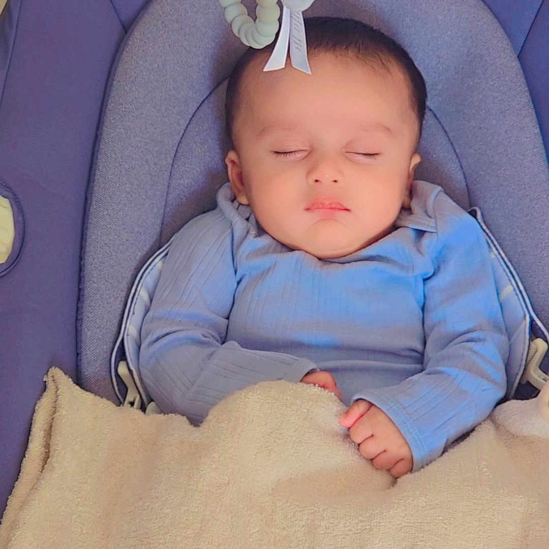 Afnan joined the competition — help win amazing prizes! baby, sleeping, blanket, blue_clothing, baby_seat, plush_toy, cozy, infant, peaceful, child, soft_texture, indoor, cute, resting, head, closed_eyes, small_hands, comfort, naptime, portrait