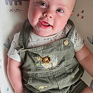 Jaxson joined the competition — help win amazing prizes! baby, baby_clothes, baby_girl_or_boy, child, cute, dinosaur_pattern, expression, face, green_clothing, happy, indoor, infant, lying_down, overalls, person, play_mat, portrait, skin, smiling, young_child