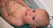 Jaxson joined the competition — help win amazing prizes! arms, baby, bath, bathroom, bathtub, child, curious, eyes, face, head, human, indoors, infant, relaxing, rosy_cheeks, skin, support, torso, water, young