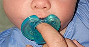 Jaxson is registered to the contest to win money with this photo: baby, infant, face, pacifier, hand, blue_clothing, closeup, skin, eyes, fingers, cute, child, people, person, mouth, expression, newborn, babywear, human, portrait