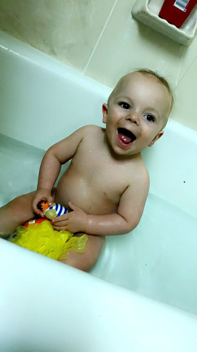 Karston is registered to the contest to win money with this photo: baby_bathing, bathing, bathroom, bathtub, chest, child, finger, fluid, fun, happy, human_body, mouth, organ, person, personal_care, plumbing, plumbing_fixture, skin, smile, toddler