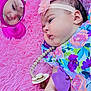 Zamira is registered to the contest to win money with this photo: baby, infant, mirror, reflection, pink_blanket, headband, flower, pacifier, colorful_clothing, floral_pattern, closeup, child, cute, soft_texture, indoors, portrait, lying_down, hand, face, baby_accessory