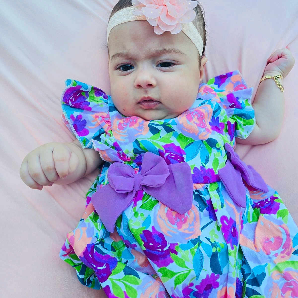 Zamira joined the competition — help win amazing prizes! baby, blanket, blue, bow, child, cute, dress, fashion, floral_pattern, flower, green, hand, headband, infant, lying_down, person, pink, portrait, purple, skin