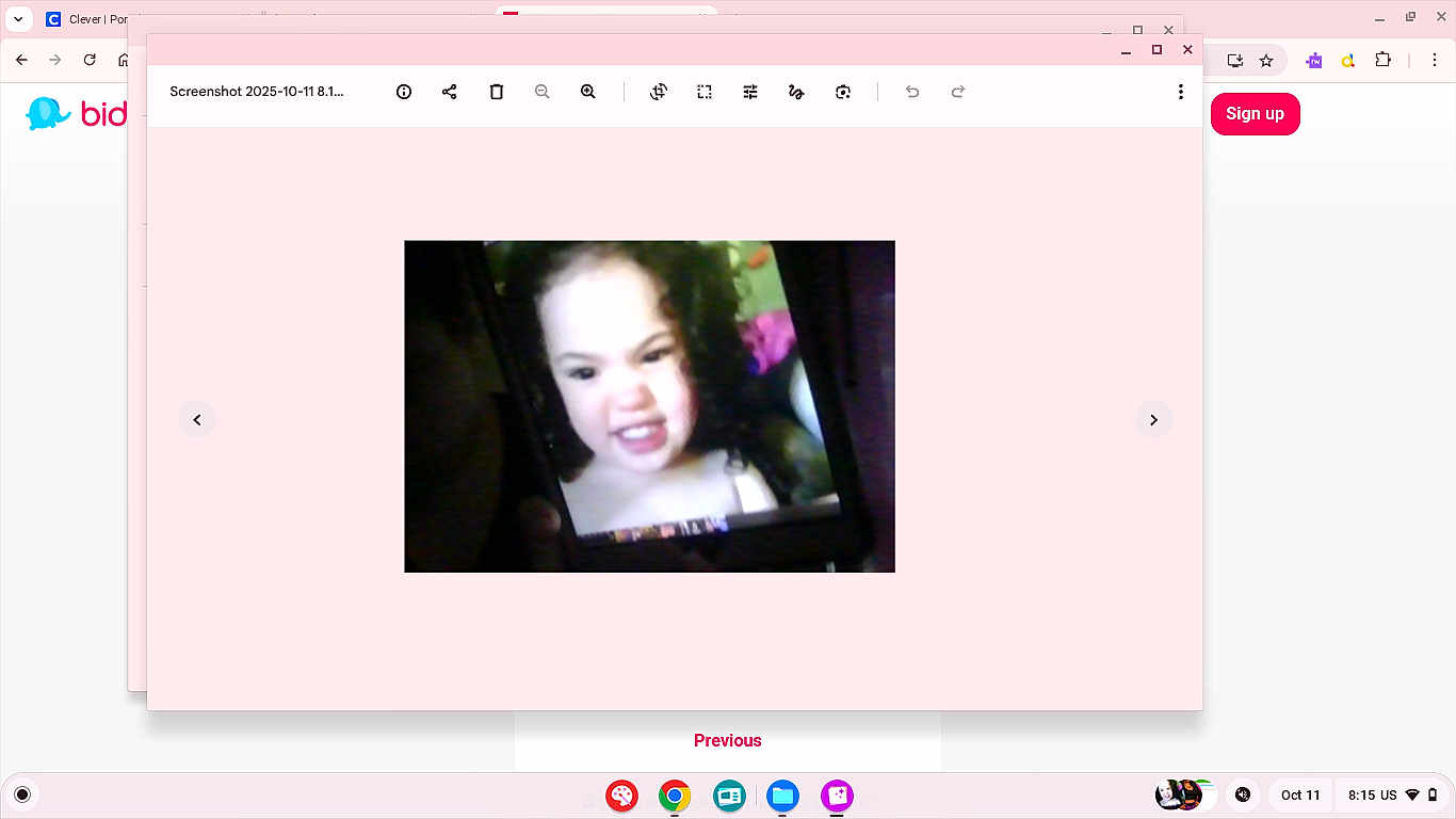 Alliyah is registered to the contest to win money with this photo: child, face, device_screen, hand, blurry, pixelated, portrait, expression, indoor, digital_photo, mobile_device, dark_background, person, young_child, scrunched_face, curly_hair, technology, photo_capture, close_up, screen