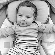 Djamaïly a rejoint le concours — aidez-le/la à gagner de superbes lots ! baby, infant, smile, striped_clothing, onesie, cushion, black_and_white, portrait, close_up, child, cute, happy, resting, soft_texture, indoor, young, person, head, face, baby_clothes