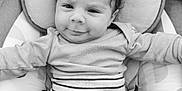 Djamaïly a rejoint le concours — aidez-le/la à gagner de superbes lots ! baby, baby_clothes, black_and_white, child, close_up, cushion, cute, face, happy, head, indoor, infant, onesie, person, portrait, resting, smile, soft_texture, striped_clothing, young