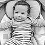 baby, infant, smile, striped_clothing, onesie, cushion, black_and_white, portrait, close_up, child, cute, happy, resting, soft_texture, indoor, young, person, head, face, baby_clothes