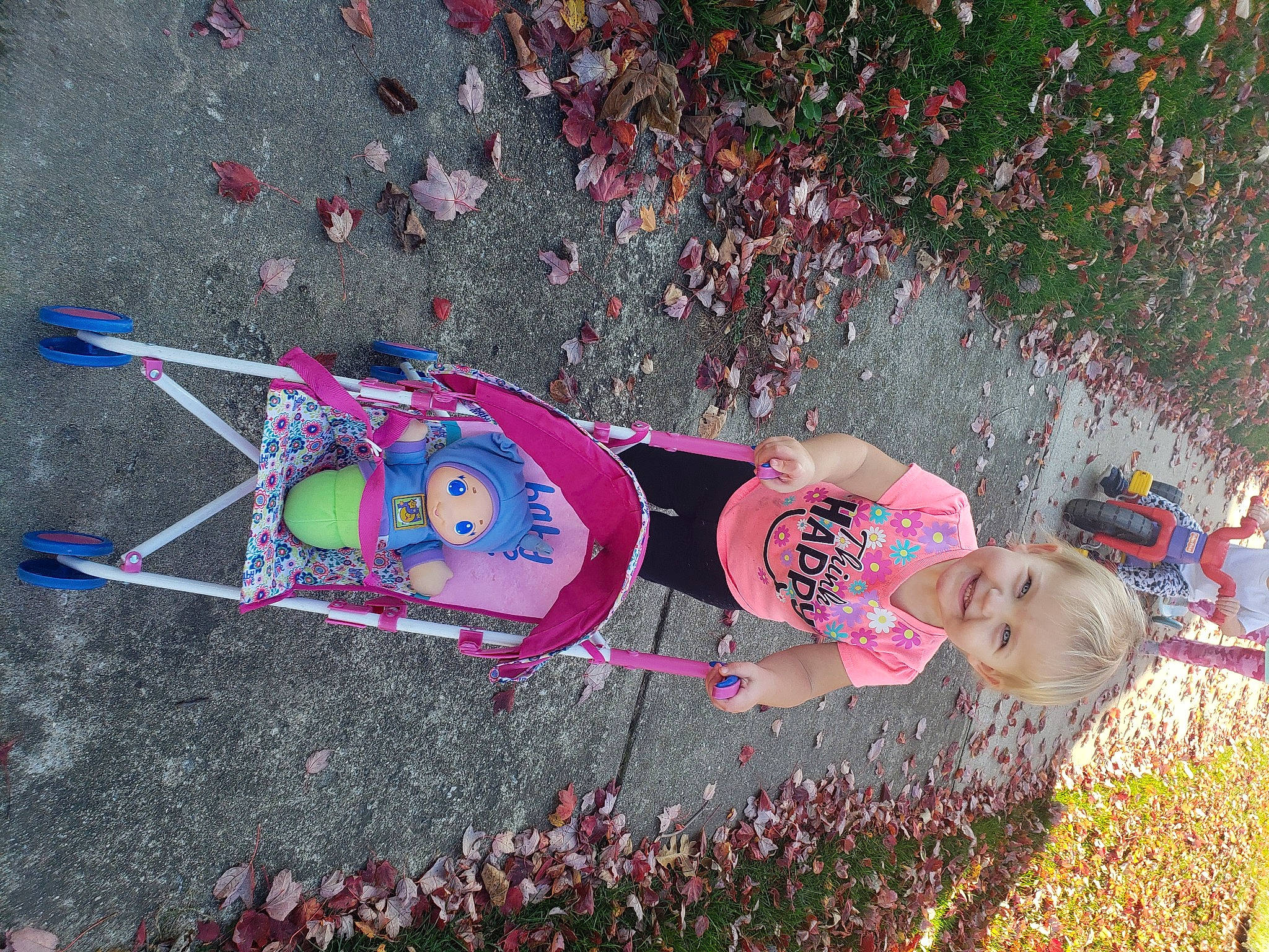 Maddilyn joined the competition — help win amazing prizes! asphalt, child, dress, fun, grass, happy, joy, leisure, magenta, party_supply, people_in_nature, person, pink, plant, recreation, road_surface, sidewalk, smile, toddler, toy