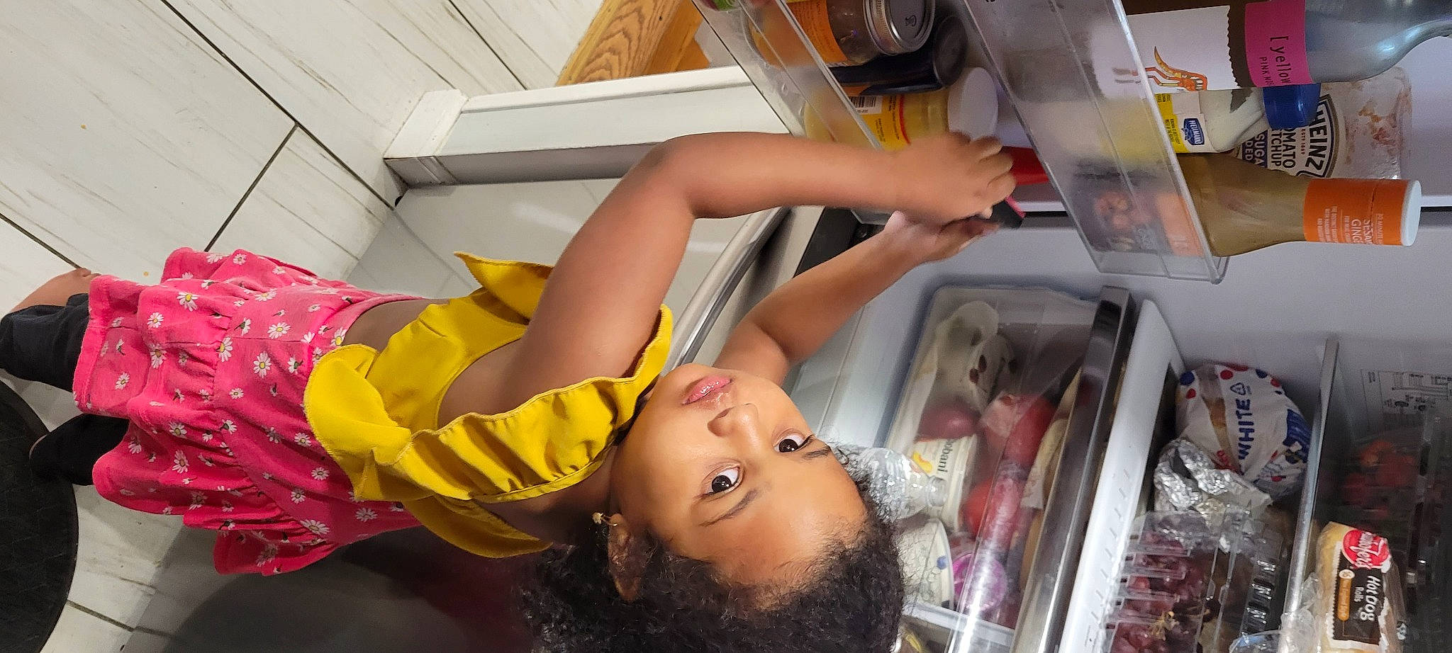 Kayla is registered to the contest to win money with this photo: abdomen, baby_products, chest, child, comfort, dress, elbow, eyelash, flesh, flooring, fun, happy, human_leg, leisure, major_appliance, person, room, textile, thigh, toddler