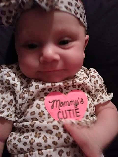 Geneva is registered to the contest to win money with this photo: cheek, child, day, face, girl, hair_accessory, head, headgear, infant, lip, nose, pattern, person, pink, product, skin, smile, toddler