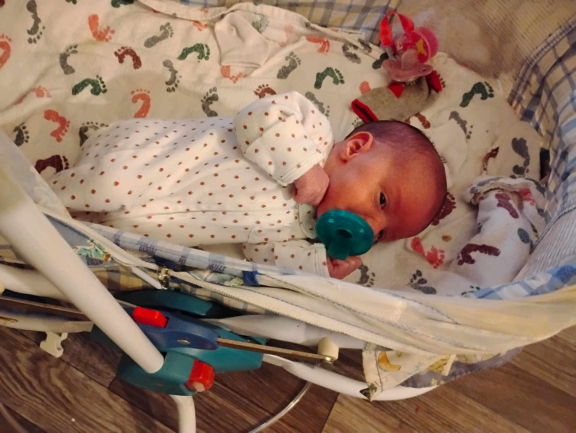 Kate joined the competition — help win amazing prizes! baby, infant, pacifier, bassinet, blanket, footprint_pattern, onesie, sleepwear, baby_clothing, newborn, crib, baby_bed, wooden_floor, baby_accessory, sock, baby_sleeping, baby_face, baby_hand, baby_lying, cozy