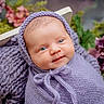baby, infant, portrait, knit, purple, blanket, bonnet, face, smile, blue_eyes, cute, newborn, soft_texture, flower, flowers, greenery, closeup, headwear, wrapped, peaceful