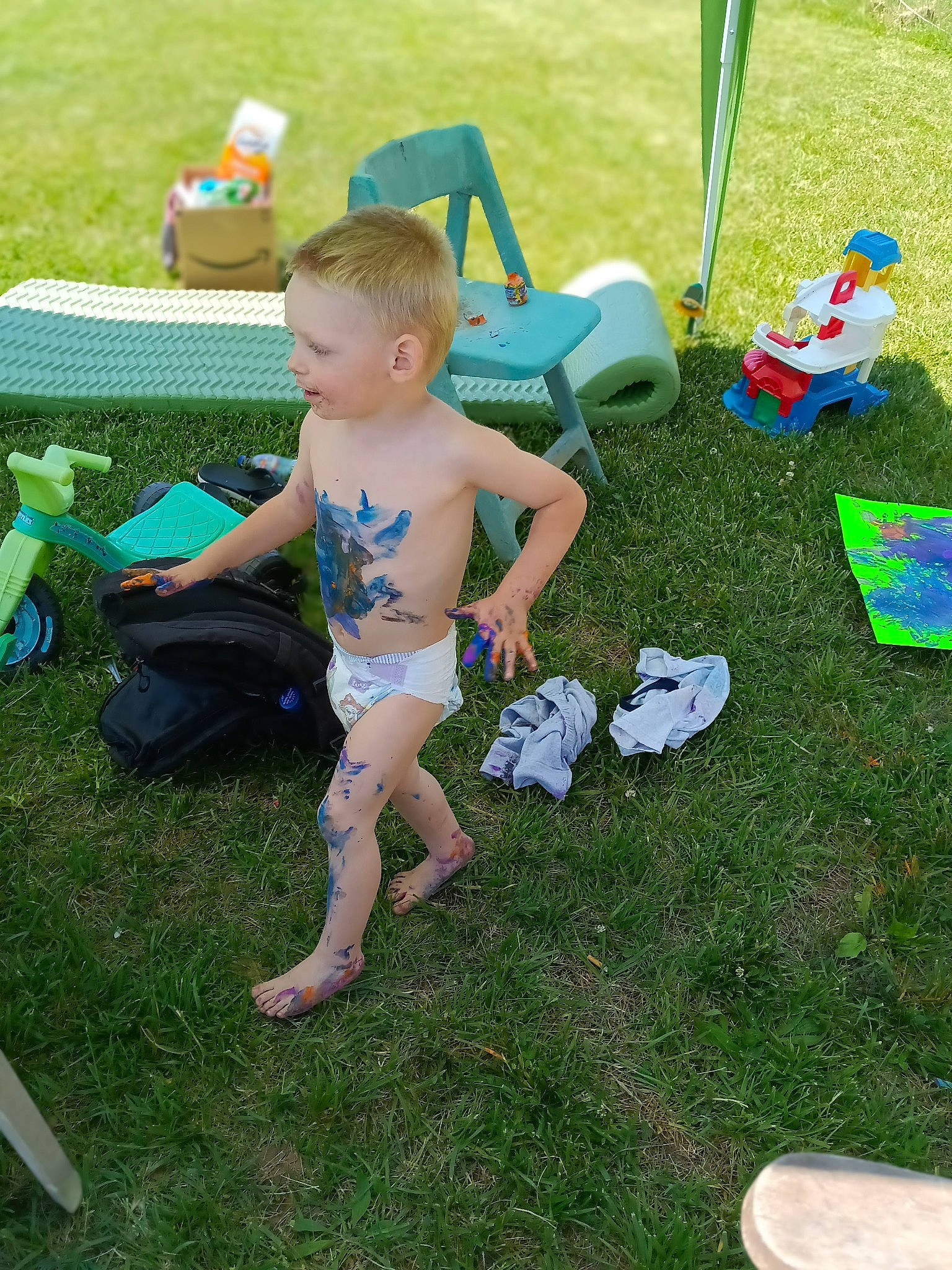 William is registered to the contest to win money with this photo: baby_toddler_clothing, barefoot, chair, child, event, foot, fun, grass, grass_family, green, lawn, leisure, outdoor_furniture, people_in_nature, person, recreation, sharing, shoe, shorts, sitting
