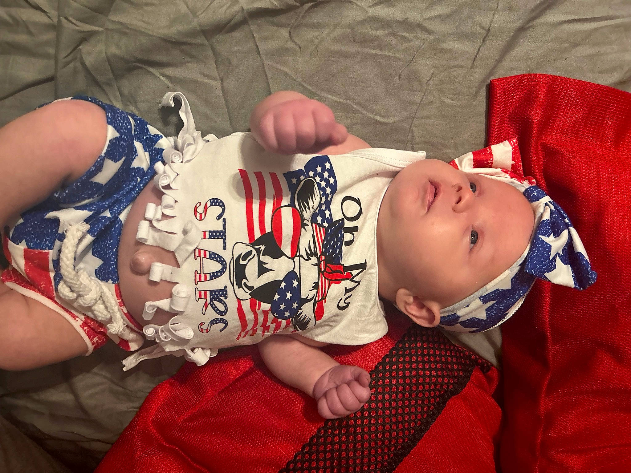 Kimberlyn is registered to the contest to win money with this photo: baby, baby_toddler_clothing, cheek, chest, child, comfort, elbow, eye, facial_expression, finger, head, headgear, headwear, human_body, mouth, person, skin, sleeve, t_shirt, thigh