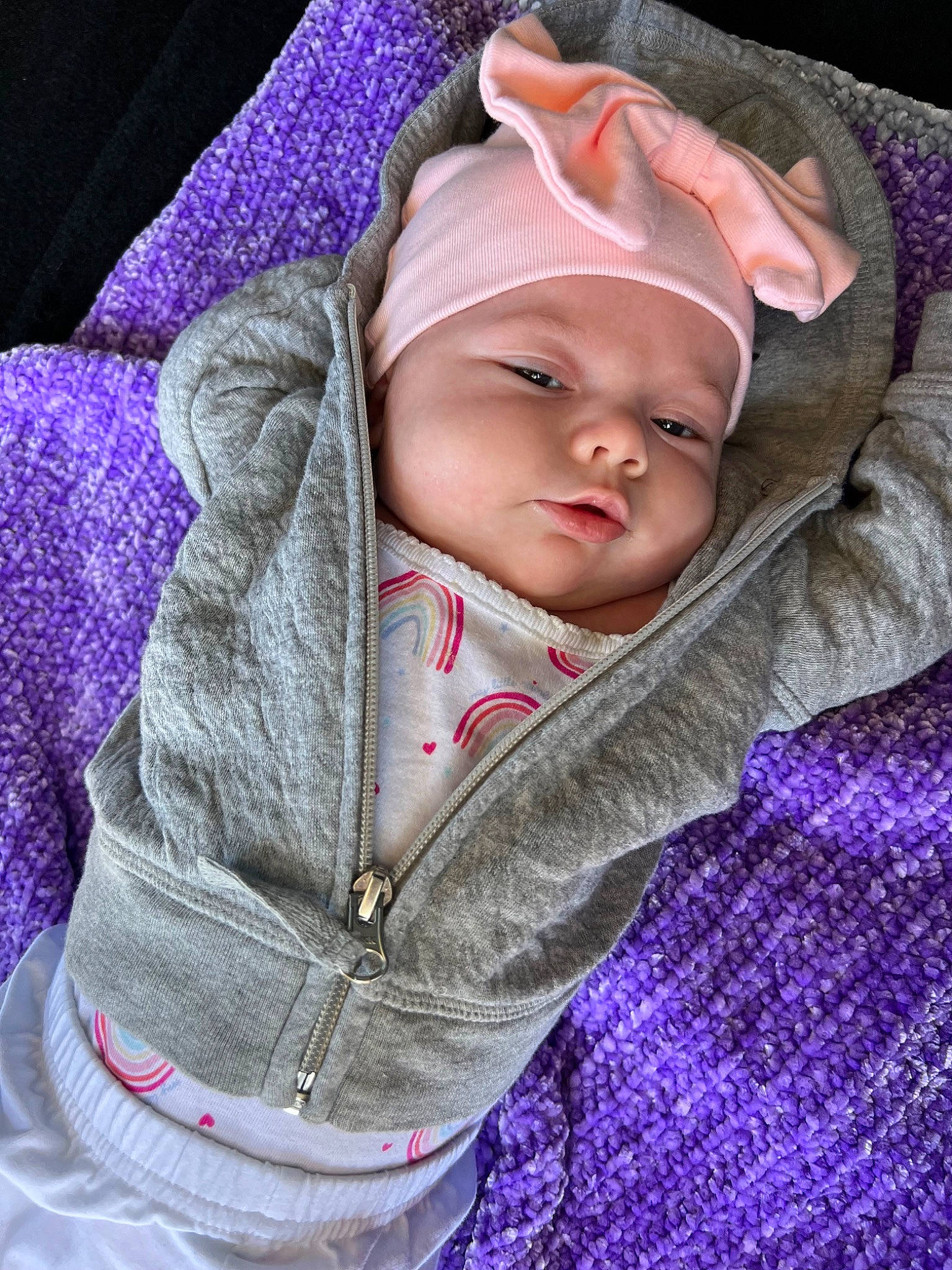 Kourtney is registered to the contest to win money with this photo: baby, baby_toddler_clothing, cheek, comfort, eye, face, headwear, iris, knit_cap, lip, magenta, nose, outerwear, person, pink, product, purple, skin, sleeve, textile