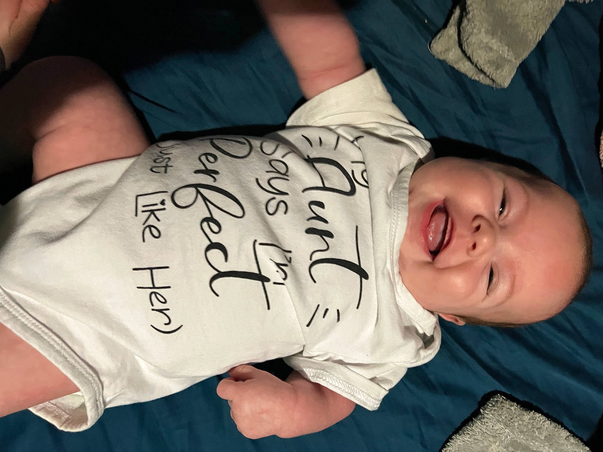 Kourtney joined the competition — help win amazing prizes! baby, baby_toddler_clothing, cheek, child, comfort, cool, elbow, finger, font, hand, happy, hat, mammal, person, sitting, sleeve, smile, t_shirt, toddler, tree