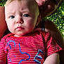 Benjamin is registered to the contest to win money with this photo: baby, adult, person, child, face, portrait, outdoor, greenery, leaf, shirt, red_clothing, expression, tongue_out, holding, skin, hair, casual, playful, nature, daylight