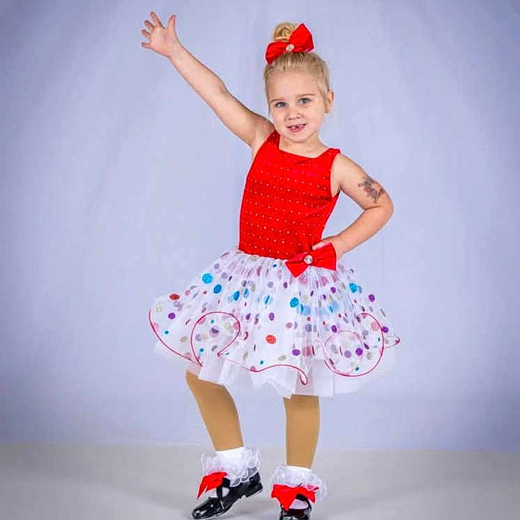 Aribella joined the competition — help win amazing prizes! background, blonde_hair, child, costume, cute, dance_pose, dress, fashion, fun, girl, happy, performance, polka_dot, posing, red_bow, shoes, smiling, studio, tutu, white_socks