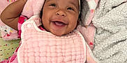 Iriland joined the competition — help win amazing prizes! baby, smiling, headband, blanket, pink, dress, strawberry_pattern, infant, happy, lying_down, cozy, cute, child, fabric, soft, bed, playful, portrait, person, indoor