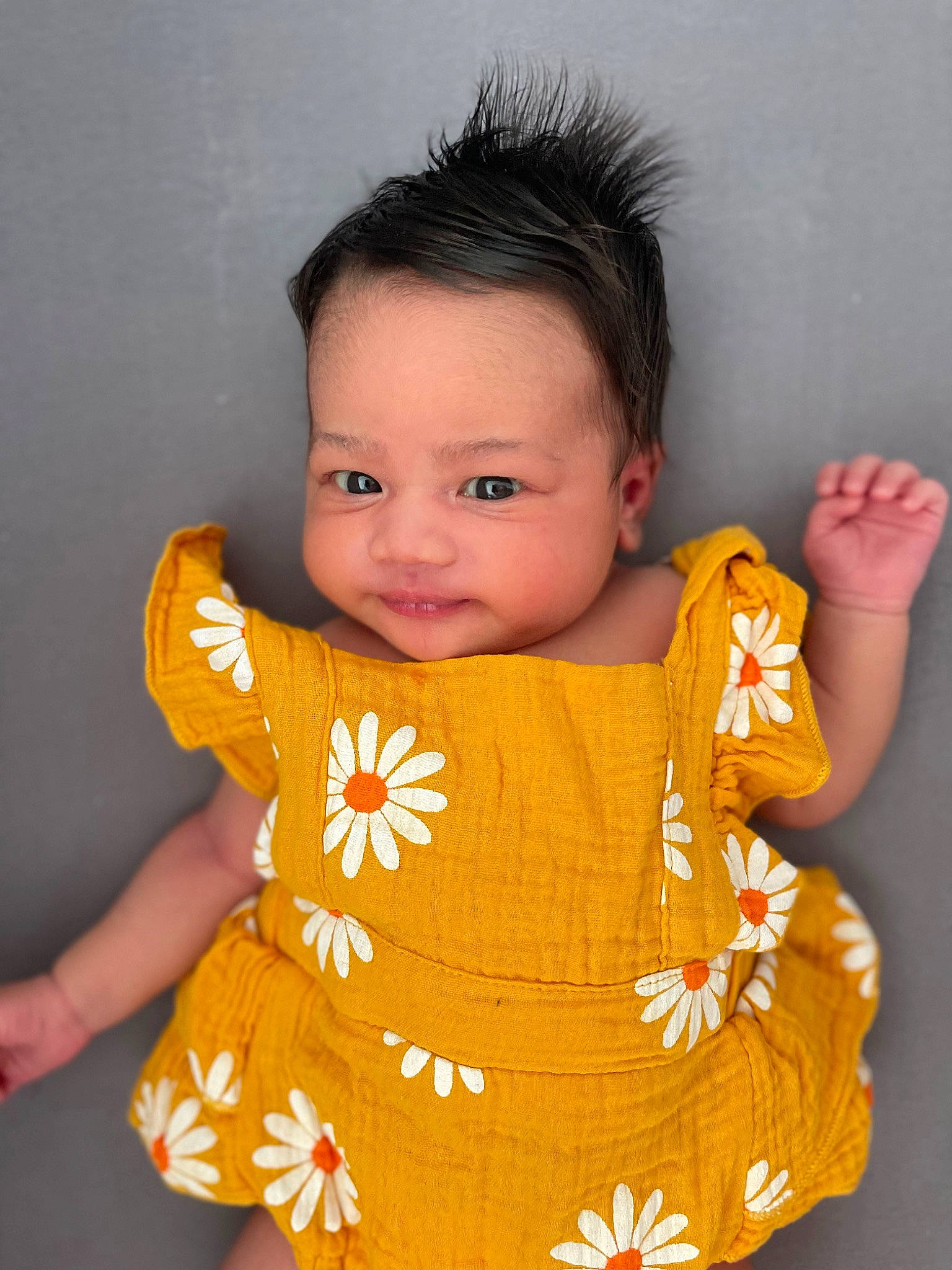 Alyssa is registered to the contest to win money with this photo: baby, baby_toddler_clothing, cheek, chin, dress, eye, face, hair, hairstyle, head, human_body, lip, neck, nose, orange, outerwear, person, shoulder, skin, sleeve