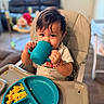 Maverick joined the competition — help win amazing prizes! toddler, child, high_chair, blue_cup, plate, scrambled_eggs, red_fruit, food, indoor, home, curly_hair, face, hands, eating, meal_time, cute, expression, person, table, kitchen