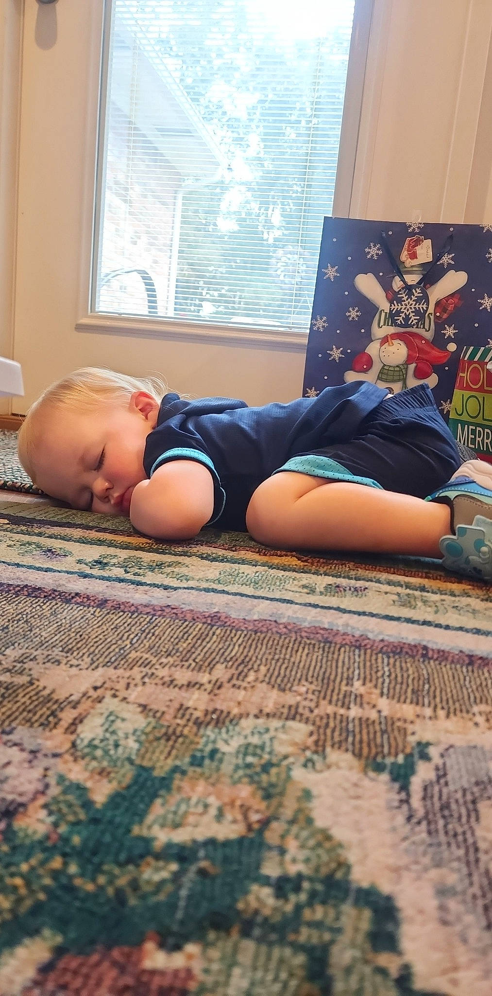 Waylin is registered to the contest to win money with this photo: barefoot, child, comfort, curtain, floor, flooring, foot, grass, hardwood, human_leg, knee, leisure, linens, pattern, person, room, shorts, sitting, thigh, toddler