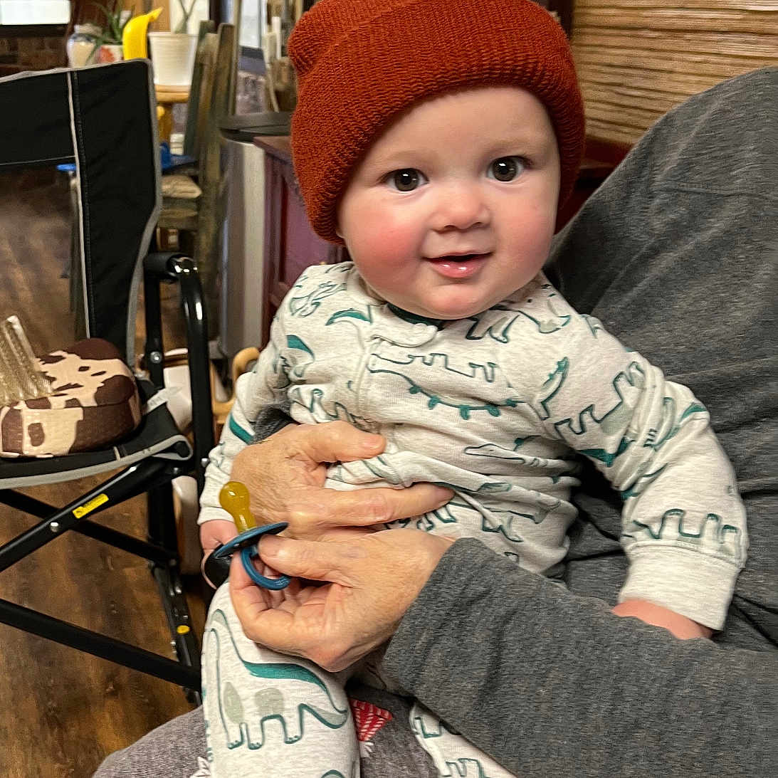 Beckett is registered to the contest to win money with this photo: baby, beanie, bodypart, cap, chair, clothing, couch, face, finger, furniture, hand, hat, head, pants, person, photography, plant, portrait, sitting, wood
