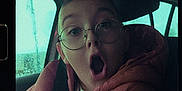 Owen participe au concours pour gagner de l'argent avec cette photo : child, glasses, pink_jacket, car, window, raindrops, surprised_expression, portrait, triptych, face, young, seatbelt, casual_clothing, indoors, headwear, eyewear, person, emotion, reaction, photography