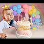 baby, birthday_cake, cake, balloons, pastel_colors, rainbow, party, celebration, child, table, decorations, pink, white, gold, face, expression, crown, one_year, festive, lights
