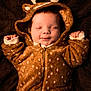 baby, infant, child, onesie, deer_costume, hood, antlers, sleeping, smile, cozy, brown, fur_texture, pajamas, blanket, portrait, closeup, cute, hands_up, zipper, newborn