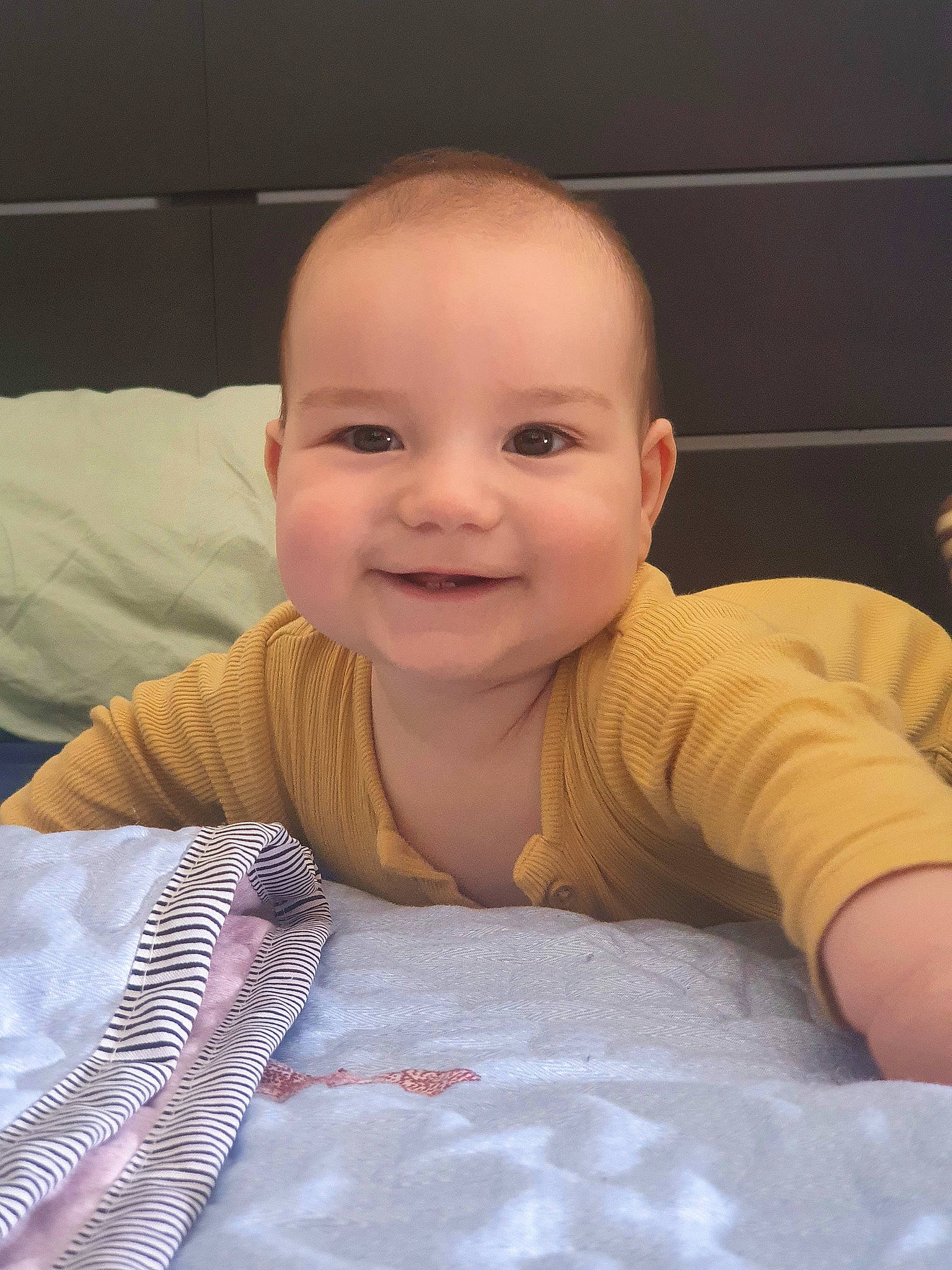 Erik is registered to the contest to win money with this photo: baby, baby_toddler_clothing, cheek, chin, comfort, eyebrow, flooring, fun, happy, iris, joy, linens, mouth, nose, person, skin, sleeve, smile, textile, thumb