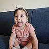 Aithana is registered to the contest to win money with this photo: baby, child, infant, smiling, sitting, couch, headband, onesie, peach, happy, cute, indoor, portrait, sock, hand, face, young, person, expression, furniture