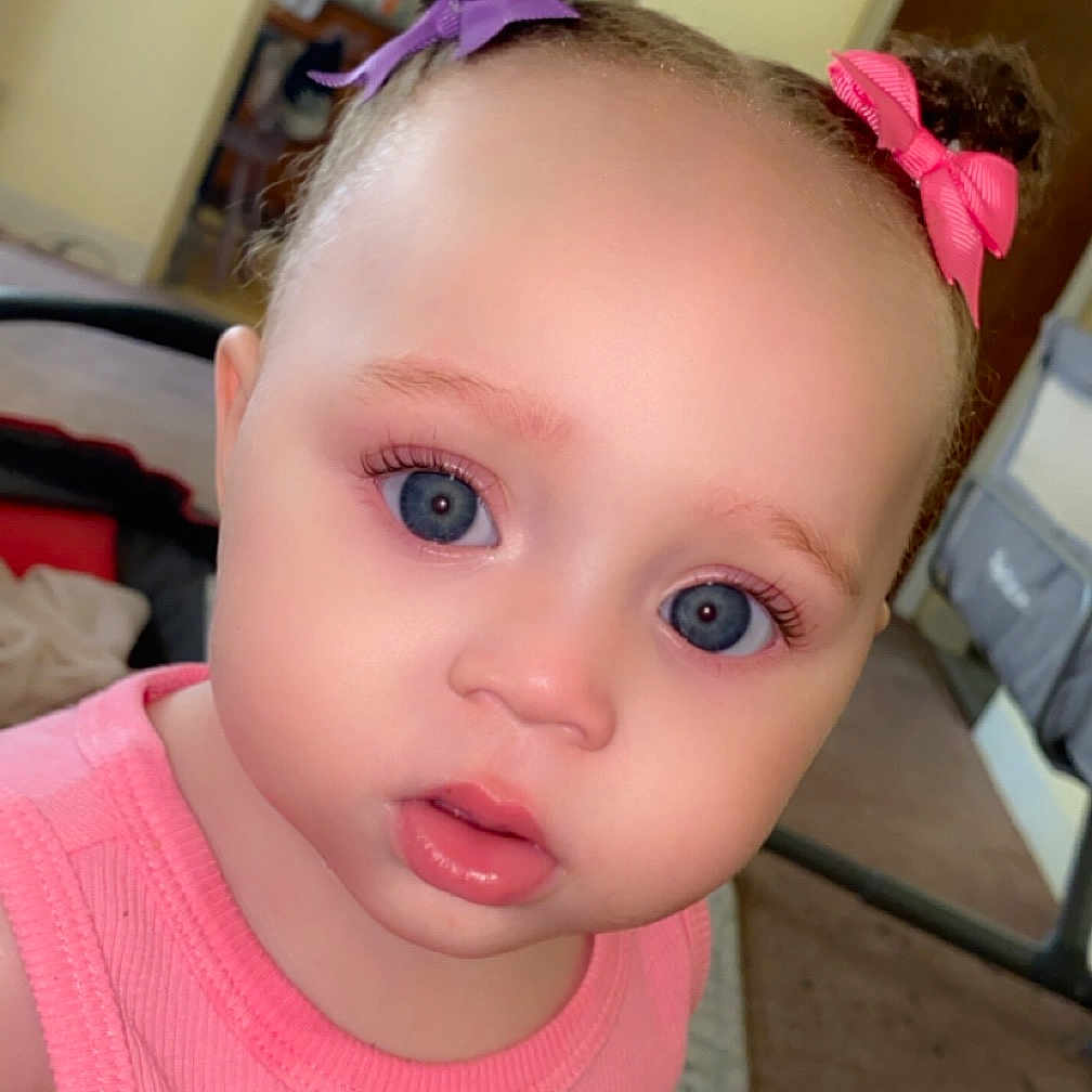 Jaelynn is registered to the contest to win money with this photo: accessories, architecture, baby, building, clothing, cosmetics, couch, face, furniture, hair, head, headband, indoors, lipstick, livingroom, person, photography, portrait, room, t_shirt