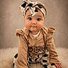 Aliya a rejoint le concours — aidez-le/la à gagner de superbes lots ! baby, child, headband, patterned_pants, beige_clothing, ruffles, fluffy_rug, cute, portrait, sitting, indoor, curious, chubby_cheeks, long_sleeves, fashion, studio_lighting, smile, young_child, infant, person