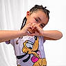 child, braids, hands, heart_shape, tshirt, cartoon, dog, smile, portrait, young, cute, happy, gesture, person, casual_clothing, white_background, playful, innocence, fun, posing