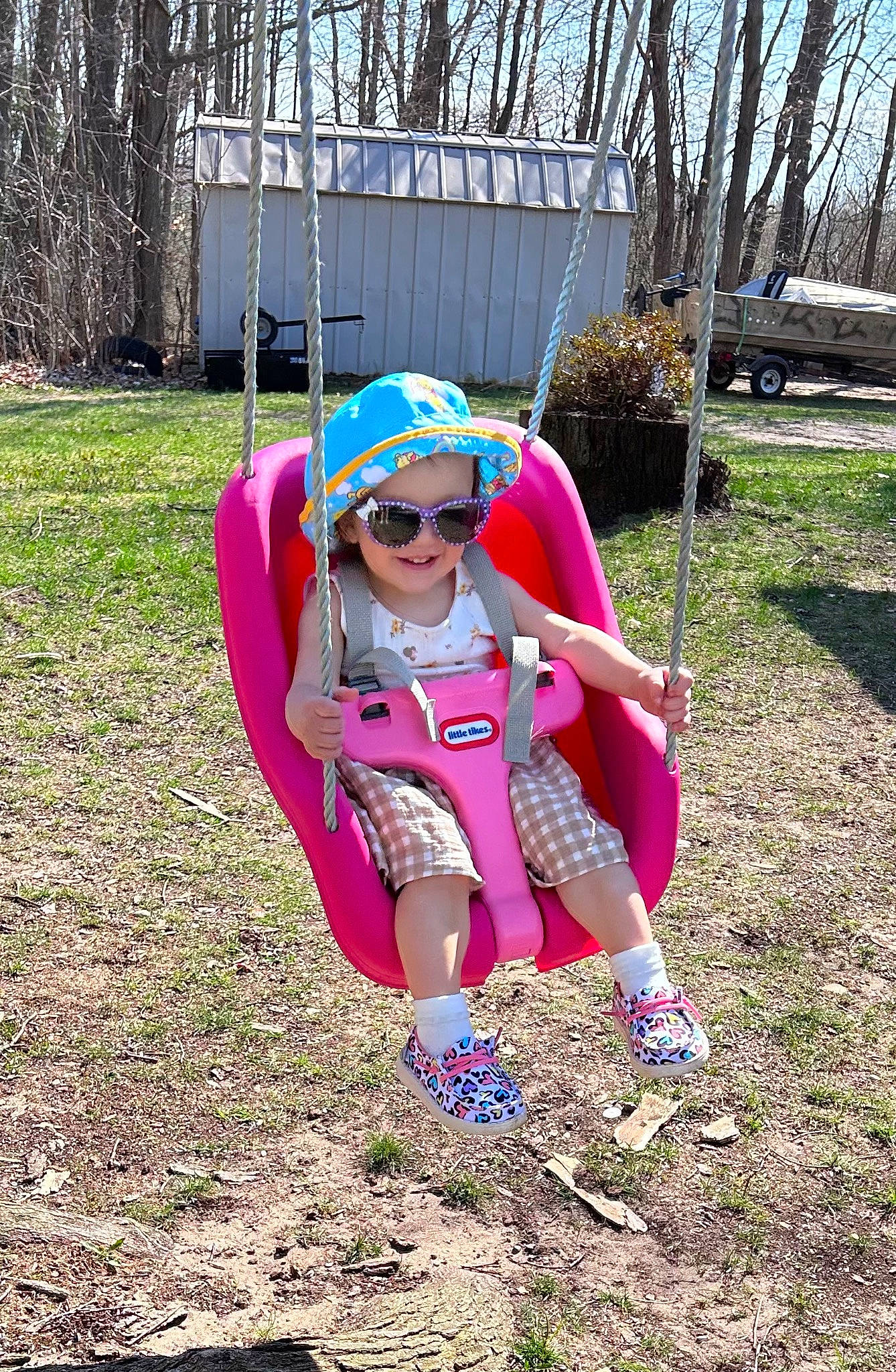 Emileigh is registered to the contest to win money with this photo: electric_blue, eyewear, goggles, grass, happy, headwear, joy, lap, leisure, magenta, people_in_nature, person, pink, plant, recreation, shorts, smile, sneakers, sunglasses, thigh