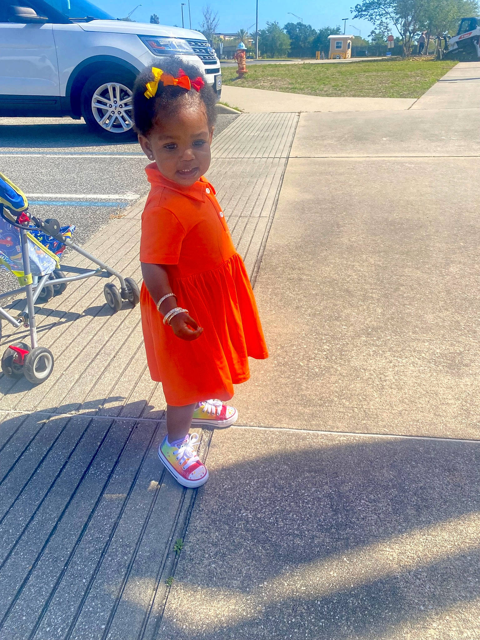 Lauren joined the competition — help win amazing prizes! asphalt, automotive_tire, automotive_wheel_system, blue, car, electric_blue, fun, hat, leisure, person, recreation, road, road_surface, sidewalk, sky, tire, toddler, tree, vehicle, vehicle_door