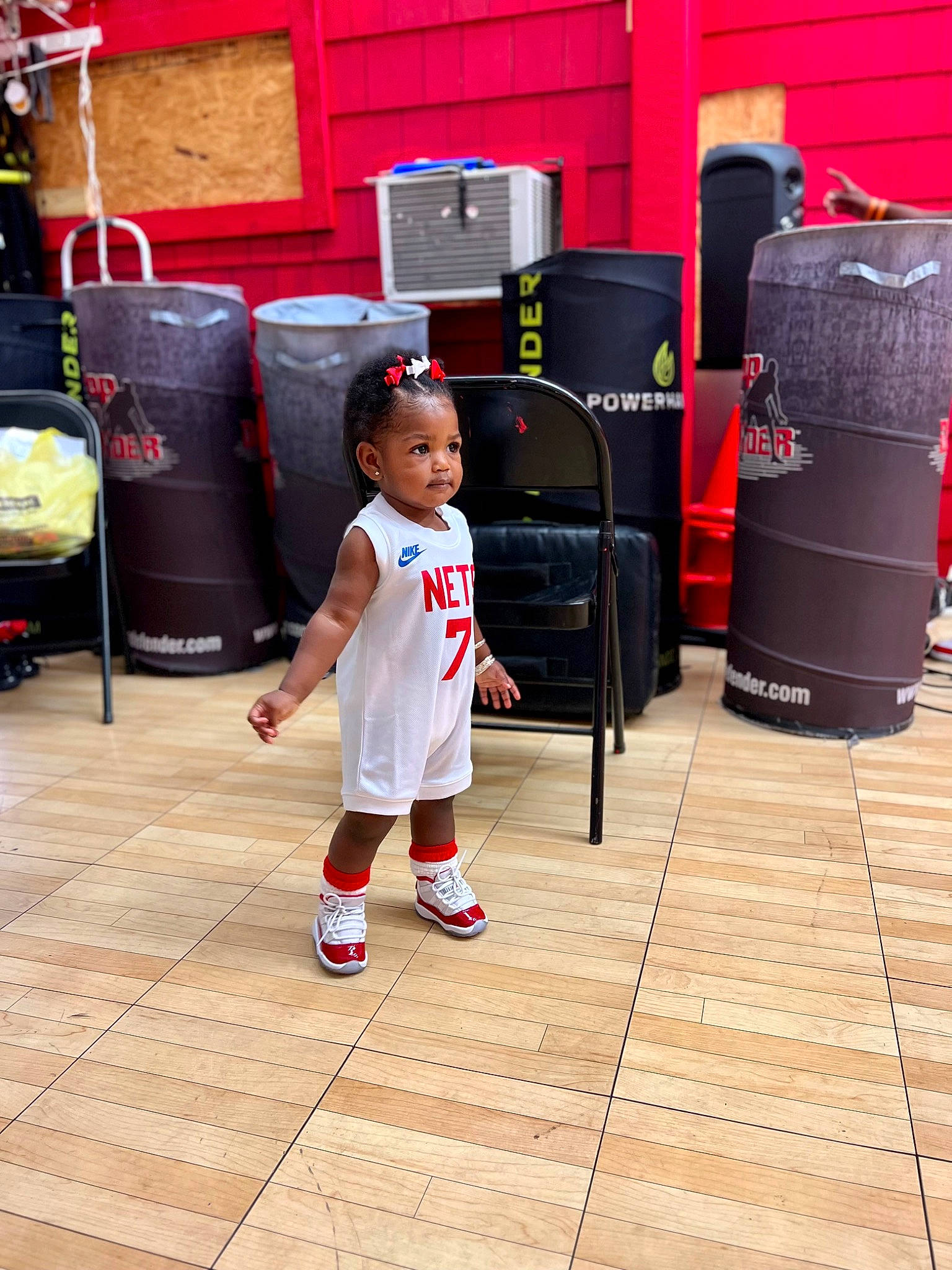 Lauren is registered to the contest to win money with this photo: bag, child, floor, flooring, fun, gas, hardwood, human_leg, luggage_and_bags, metal, person, red, service, shorts, sitting, sportswear, street, t_shirt, toddler, waste_containment