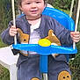 toddler, child, swing, outdoor, garden, grass, greenery, blue_swing, clothing, bear_design, pants, jacket, white_shoes, necklace, smiling, person, rope, chair, plastic_chair, happy