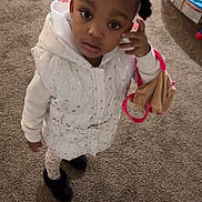 Liliana joined the competition — help win amazing prizes! toddler, child, girl, braids, indoor, carpet, vest, white_clothing, toy, play_area, pink_accessories, looking_up, standing, warm_clothing, curious_expression, home, floor, footwear, plush_toy, person