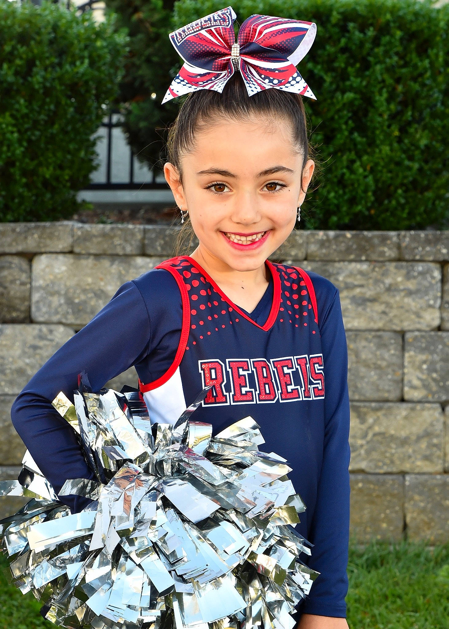 Giana is registered to the contest to win money with this photo: cheerleading, cheerleading_uniform, costume, dance, electric_blue, event, fashion, grass, happy, head, headgear, headpiece, jewellery, joy, person, photograph, smile, t_shirt, team_sport, toddler