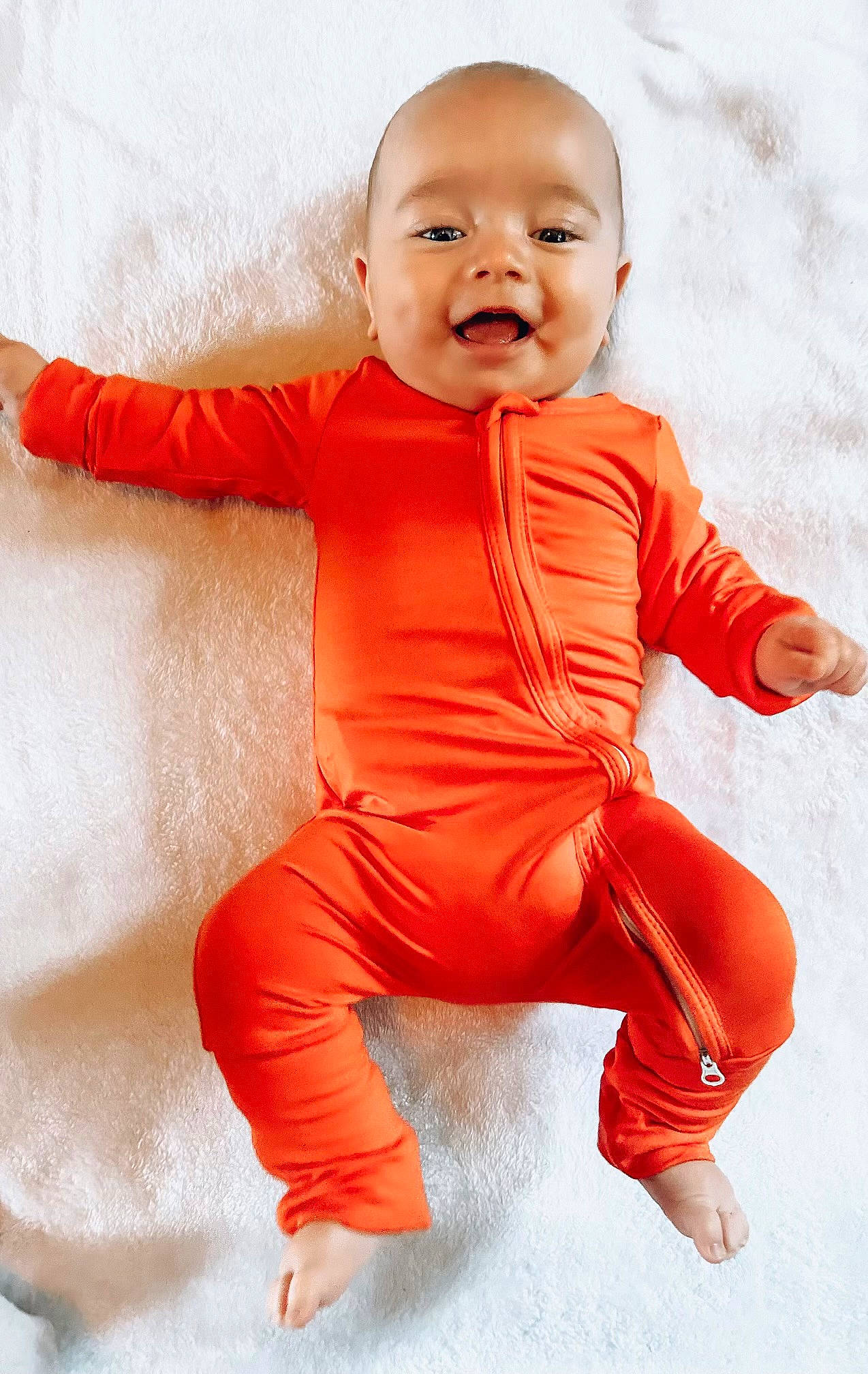 Sammy joined the competition — help win amazing prizes! arm, baby, baby_toddler_clothing, child, comfort, face, finger, flooring, fun, gesture, happy, orange, peach, person, sitting, skin, sleeve, smile, t_shirt, thumb