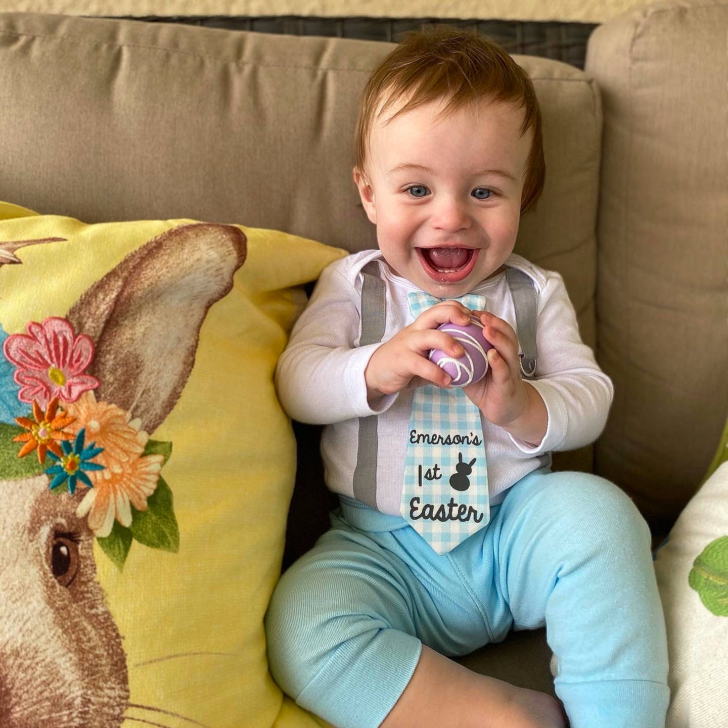 Emerson is registered to the contest to win money with this photo: arm, baby_toddler_clothing, clothing, comfort, couch, face, facial_expression, finger, furniture, green, hairstyle, happy, head, iris, leg, organ, person, pink, product, skin